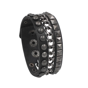 Detail of punk leather bracelet featuring multi-layer spikes, chains and snap buttons