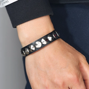 Punk style black leather bracelet featuring silver metal cone spikes and rivets