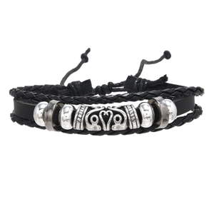 Close-up of multilayer punk leather bracelet with wing wing charms and metal beads