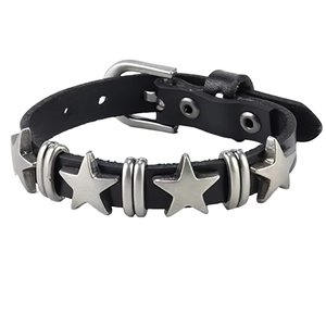 Detail of black leather punk bracelet featuring silver star rivets and buckle closure