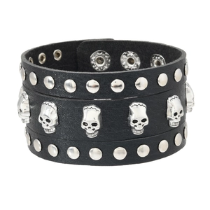Punk rock style wide black leather bracelet with silver skull charms and metal studs