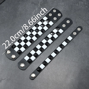 Punk black leather rivet bracelet set with white pyramid studs and snap buttons, 22cm long