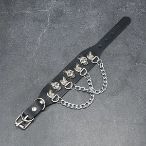 Detail view of black PU leather punk bracelet with silver skulls, spikes and metal chains