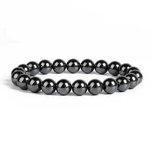 Detailed view of polished hematite stone beads on a minimalist string bracelet