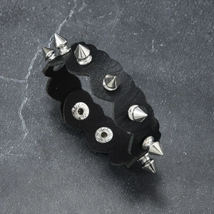 Punk black leather bracelet with silver conical metal spikes and waved edges