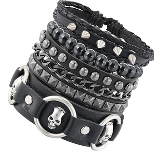 4-piece punk leather bracelet set for men featuring metal chains, studs, and skull charms