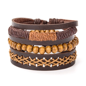 Detailed view of multilayer leather bracelets with wood beads and punk wing charms