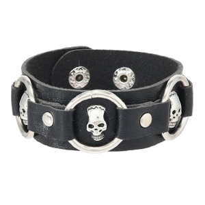 Detail of punk leather bracelet with silver skull rings and metal rivet studs