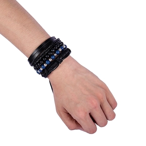 Close-up of multilayer leather and bead bracelets set with blue accents for men