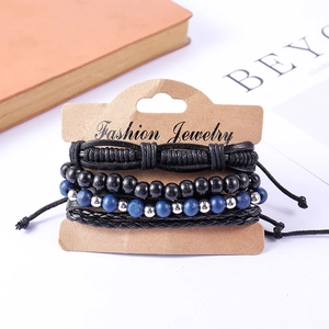 Detail of multi-layer beaded bracelet set with braided leather and black wooden beads