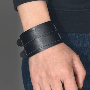 Men's punk style black layered leather bracelet with wide triple-strap design on wrist