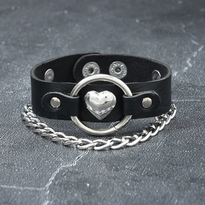 Detail of a punk leather choker featuring a silver metal ring and heart pendant detail