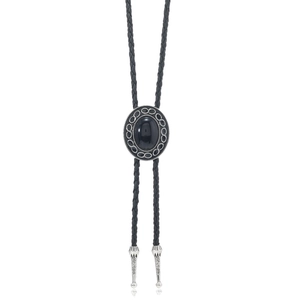 Detail of vintage bolo tie with oval black stone and silver engraved tips on braided leather cord