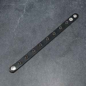 Detail of punk leather bracelet with silver metal spikes and adjustable snap buttons
