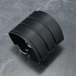 Detailed view of layered black leather punk wristband with adjustable silver metal buckles
