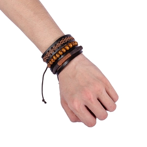 Close-up of multilayer leather bracelet with wooden beads on wrist in a retro punk style