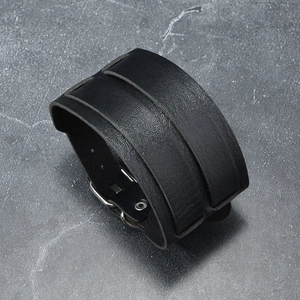 Macro detail of high-quality black leather wristband with silver metal buckle and texture