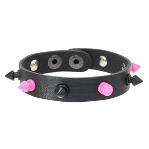 Detail of punk leather bracelet featuring pink and black cone studs and adjustable snap buttons