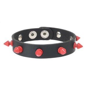 Detail of black leather punk bracelet featuring red cone spikes and silver snap fasteners