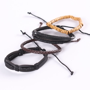 Detail of 4-piece vintage braided leather and wood bead bracelets with adjustable knots