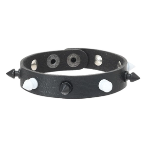 Detail of punk leather bracelet with black and white spikes and silver snap fasteners