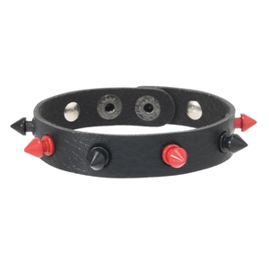 Detail of punk leather bracelet with alternating red and black spikes and silver snaps