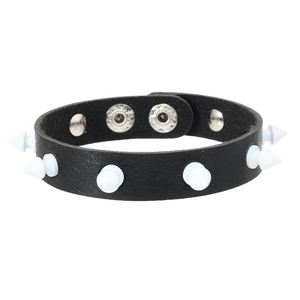 Detail of punk leather bracelet with white cone studs and silver snap fastener