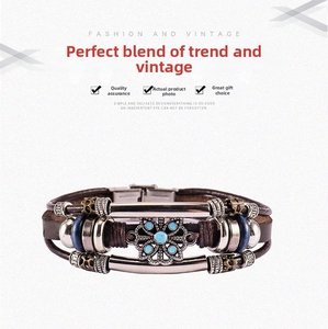 Close-up of multilayer leather bracelet with bronze floral charm and blue stones