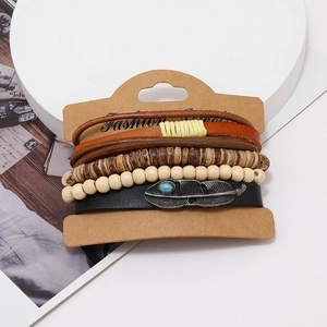 Detail of vintage bohemian leather bracelet set with silver feather charm and turquoise bead
