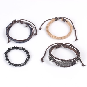 Detail of four-piece layered bracelet set with feather pendant and woven beads