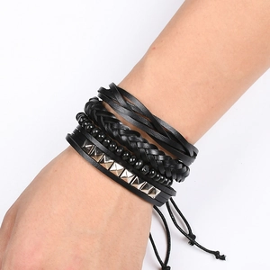 Detail of multi-layer black leather bracelet with silver pyramid studs and beads