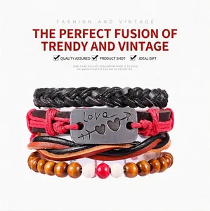 Detail of multi-layer leather bracelet with 'Love' metal plate and wooden beads