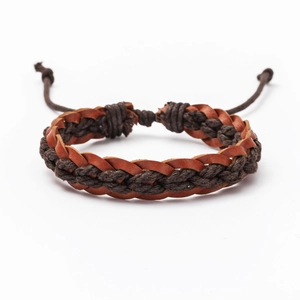 Detail of vintage woven leather bracelet with adjustable cords and bohemian textures