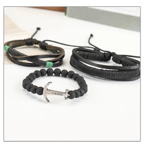 Close-up of three-piece men's punk leather bracelets with Vikings anchor and matte beads