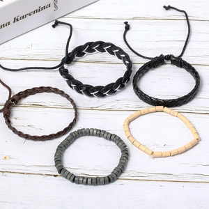 Five-piece vintage boho bracelet set with wooden beads and woven leather on white wood