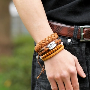 Vintage multi-layer leather bracelet set with leaf metal charm and wooden beads on wrist