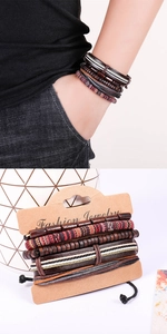 Detail of multi-layer handmade braided leather bracelets with wooden beads and wax cords