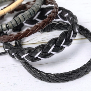 Retro multi-layer braided leather and wooden bead bracelet set on white wood background