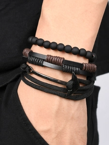 Detail of multi-layer men's vintage leather bracelets with anchor charm and matte beads