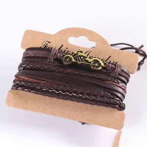 Close-up of a punk-style multilayer leather bracelet with bronze motorcycle pendant detail