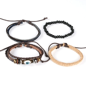 Set of four bohemian style bracelets with leather, beads, and evil eye charm in dark tones