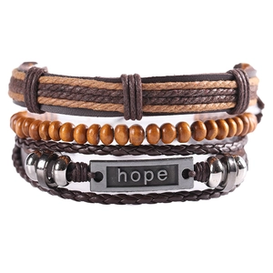 Detail of multi-layer leather bracelet set with wooden beads and hope metal plate