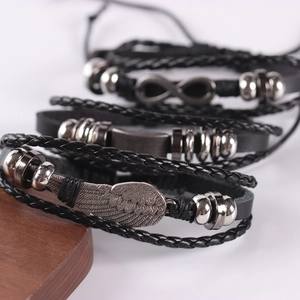 Black multilayer leather bracelet set with silver wing and infinity metal charms