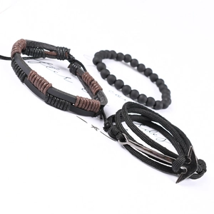 Detailed view of 3-piece men's bracelet set with black leather, beads and silver metal anchor