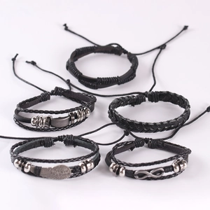 Men's 5-piece leather bracelet set with metal wing and infinity charms on white background