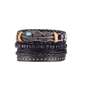 Close-up of multilayer leather bracelet featuring a silver feather with turquoise stone