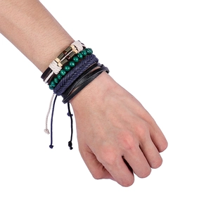 Detail of multi-layer ethnic leather bracelet set with woven ropes and vintage beads