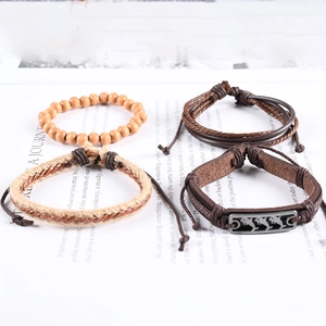Set of four vintage ocean dolphin charm bracelets with leather cords and wooden beads