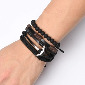 Men's multi-layer bracelet set with black beads, woven leather, and silver anchor charm