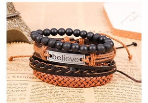 Detail of multi-layer leather bracelet set with Believe metal plate and black beads